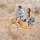 Katie and Greg on a bicycle built for two, in happier times